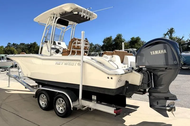 Slide: The Image of 2025 Key West 239 FS boat on trailer under clear blue sky. - 2