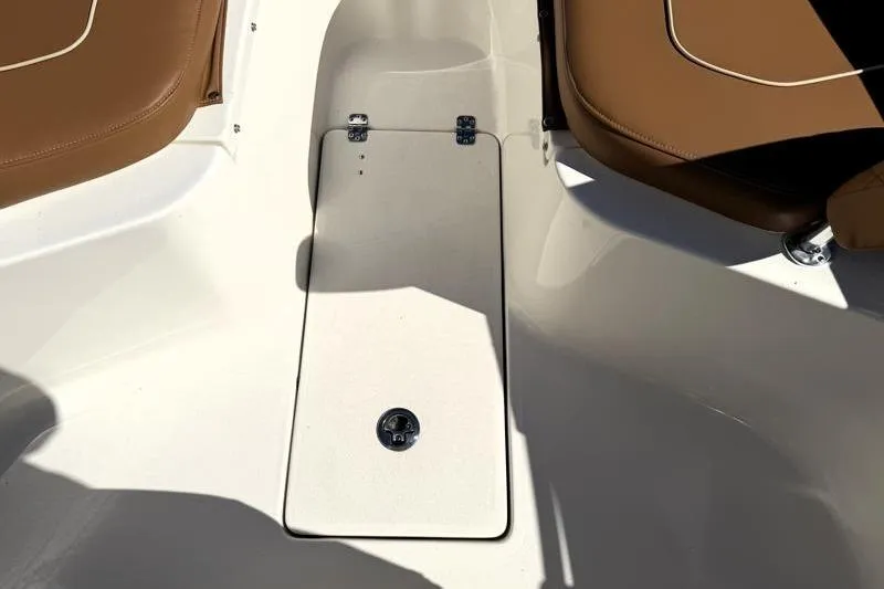 Slide: The Image of 2025 Key West 239 FS boat interior with brown seating and storage compartment. - 20