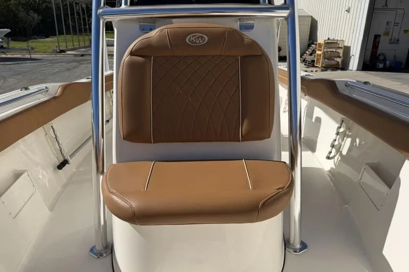 Slide: The Image of 2025 Key West 239 FS boat with tan cushioned seating and stainless steel frame. - 21