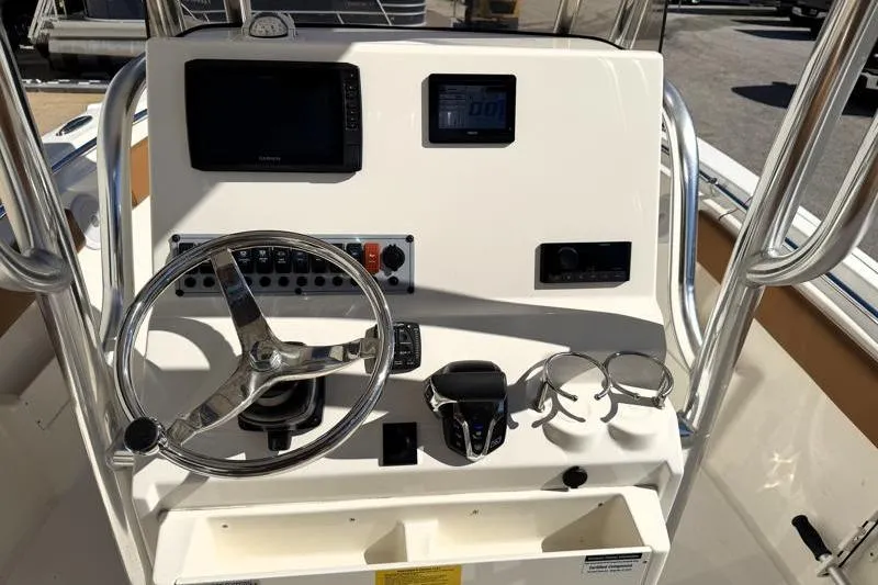 Slide: The Image of 2025 Key West 239 FS boat console with steering wheel, controls, and navigation screens. - 28