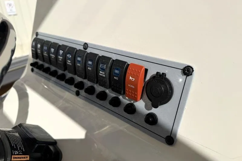 Slide: The Image of Control panel of 2025 Key West 239 FS boat with labeled switches and horn button. - 31