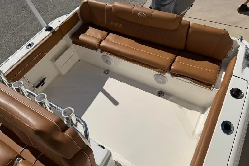Slide: The Image of 2025 Key West 239 FS boat interior with brown leather seating and rod holders. - 35