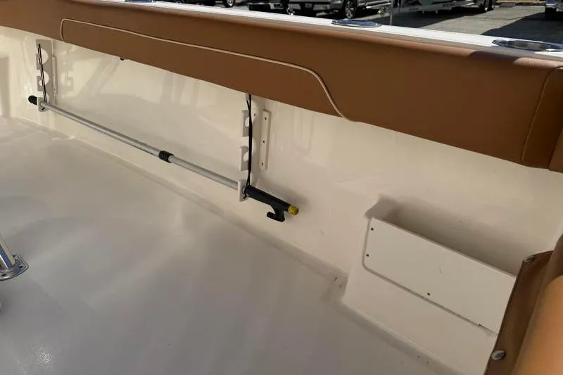 Slide: The Image of 2025 Key West 239 FS boat interior with tan upholstery and mounted equipment. - 39