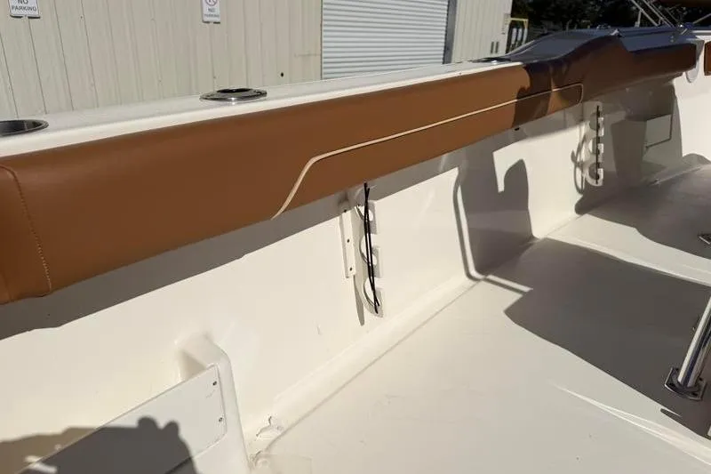 Slide: The Image of 2025 Key West 239 FS boat interior with tan upholstery and rod holders. - 40