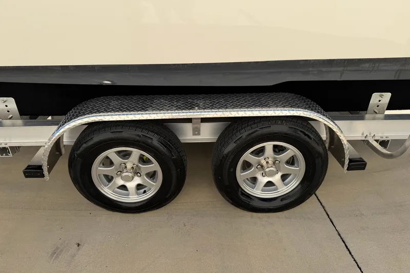 Slide: The Image of 2025 Key West 239 FS boat trailer with dual wheels on concrete surface. - 44