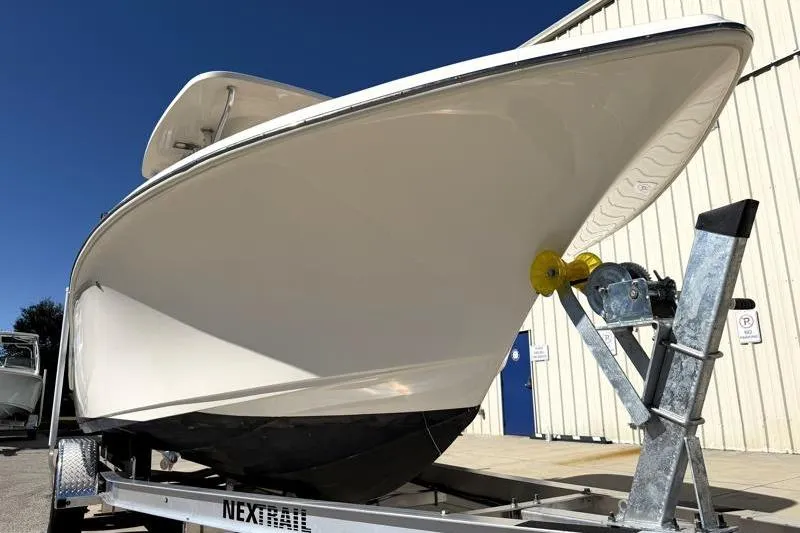 Slide: The Image of 2025 Key West 239 FS boat on trailer, parked near a building. - 8