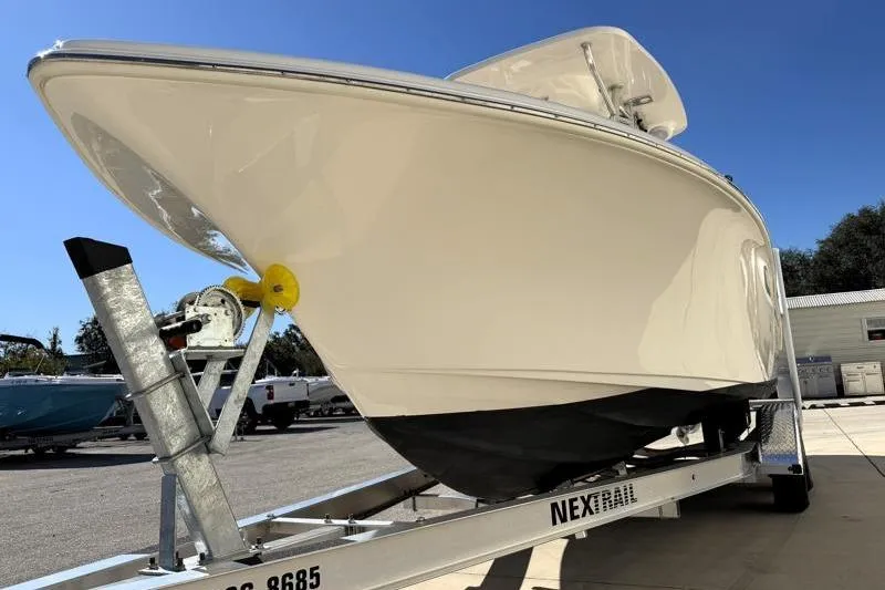 Slide: The Image of 2025 Key West 239 FS boat on trailer under clear blue sky. - 9