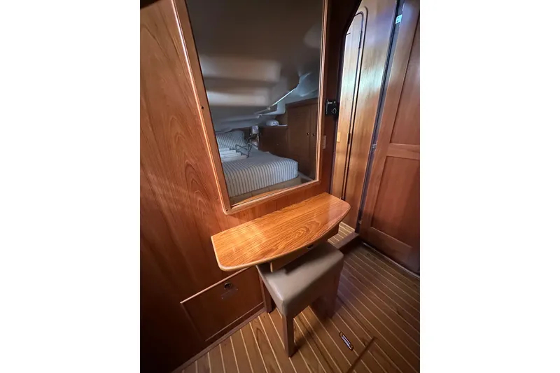 Slide: The Image of Interior of 2003 Catalina 470 yacht with wooden vanity and mirror. - 13