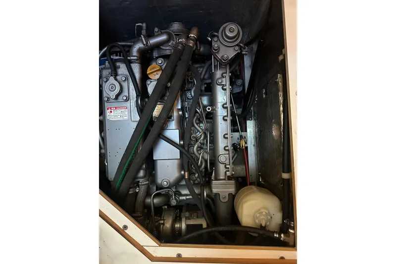 Slide: The Image of Engine compartment of a 2003 Catalina 470 sailboat, showcasing mechanical components. - 19