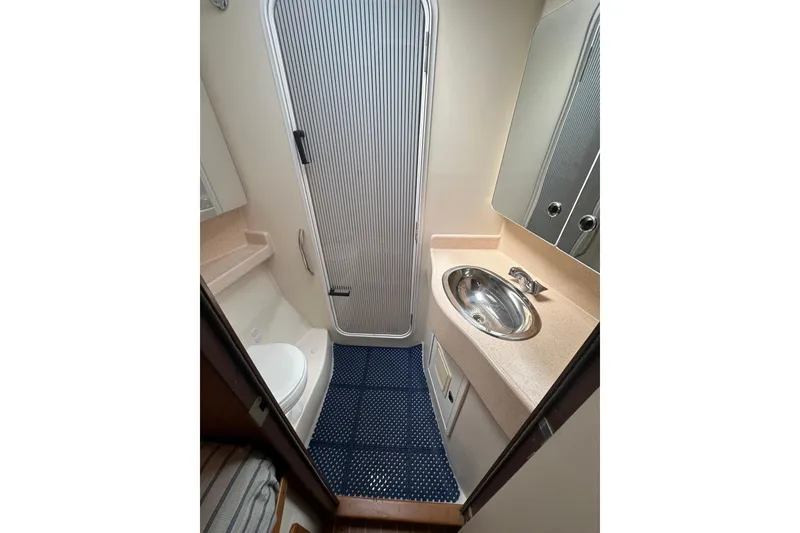 Slide: The Image of Bathroom interior of 2003 Catalina 470 yacht with sink, toilet, and shower. - 24