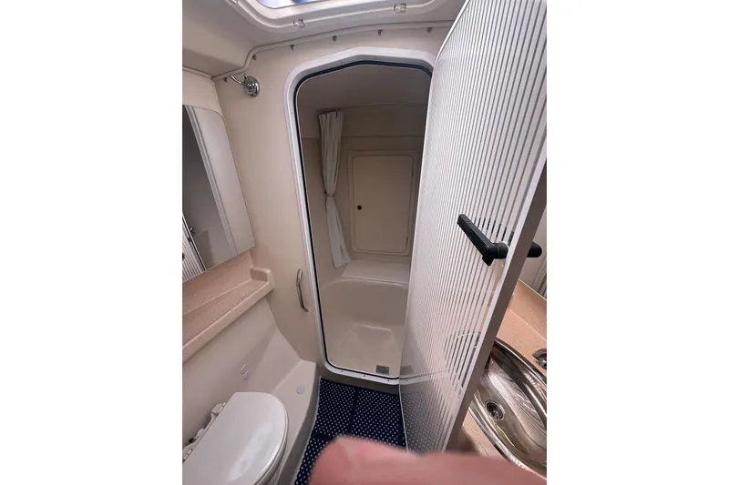 Slide: The Image of Bathroom interior of a 2003 Catalina 470 yacht, featuring shower and sink. - 25