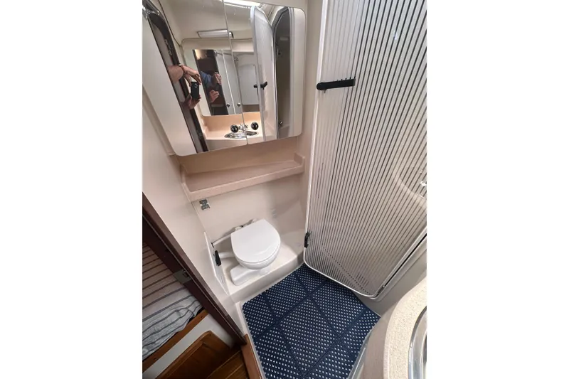 Slide: The Image of Compact bathroom in 2003 Catalina 470 yacht with toilet, mirror, and shower. - 26
