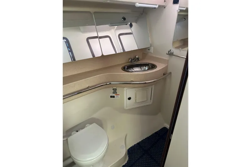 Slide: The Image of 2003 Catalina 470 yacht bathroom with sink, mirror, and toilet. - 9