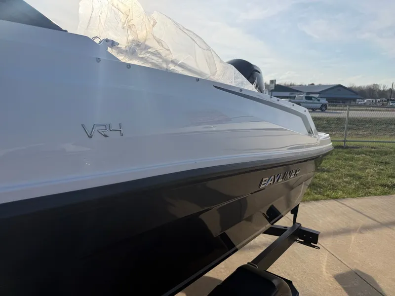 Slide: The Image of 2026 Bayliner VR4 Bowrider OB boat side view. - 3