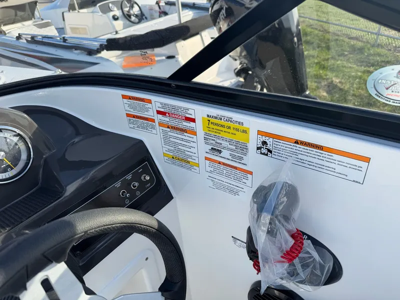 Slide: The Image of Bayliner VR4 Bowrider OB 2026 dashboard with warning labels and controls. - 9