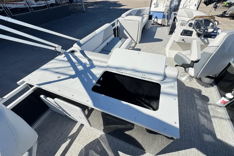 Slide: The Image of 2025 Avalon 2385 Rear Fish boat interior with seating and steering console. - 10
