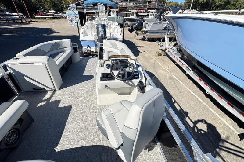 Slide: The Image of 2025 Avalon 2385 Rear Fish pontoon boat interior with seating and steering console. - 8