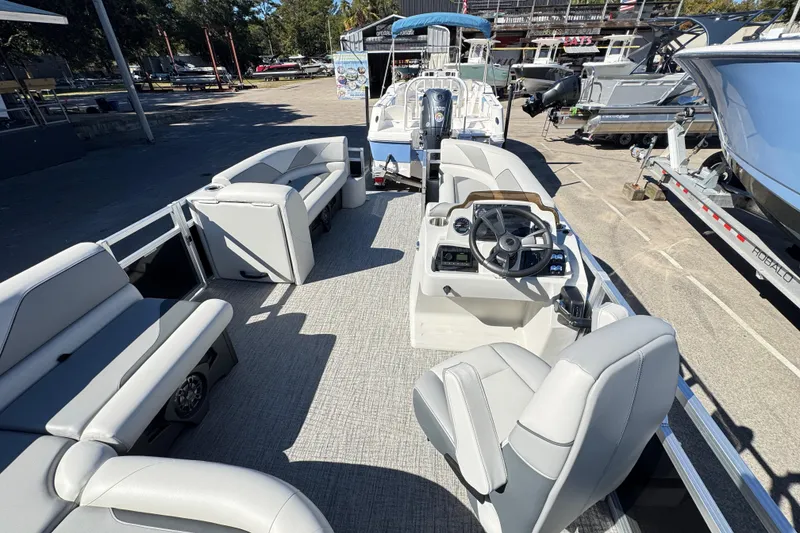 Slide: The Image of 2025 Avalon 2385 Rear Fish pontoon boat interior with seating and steering console. - 9