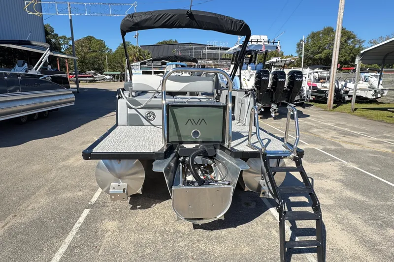 Slide: The Image of 2025 Avalon LSZ 2585 CRB pontoon boat with triple engines, docked outdoors. - 4