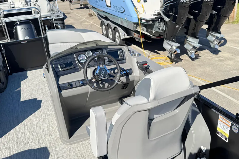 Slide: The Image of 2025 Avalon LSZ 2585 CRB boat interior with steering console and seating. - 7