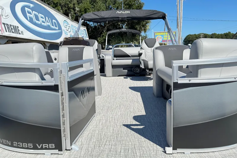 Slide: The Image of 2025 Avalon Venture 2385 VRB pontoon boat with sleek seating and modern design. - 2