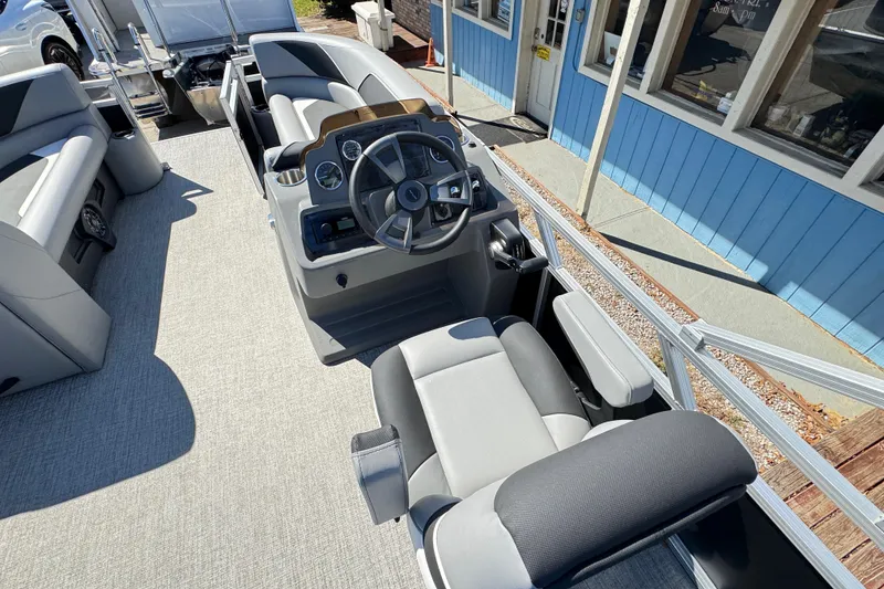 Slide: The Image of 2025 Avalon Venture 2385 VRB boat interior with steering console and seating. - 4