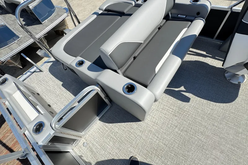 Slide: The Image of 2025 Avalon Venture 2385 VRB boat interior with gray seating and cup holders. - 6