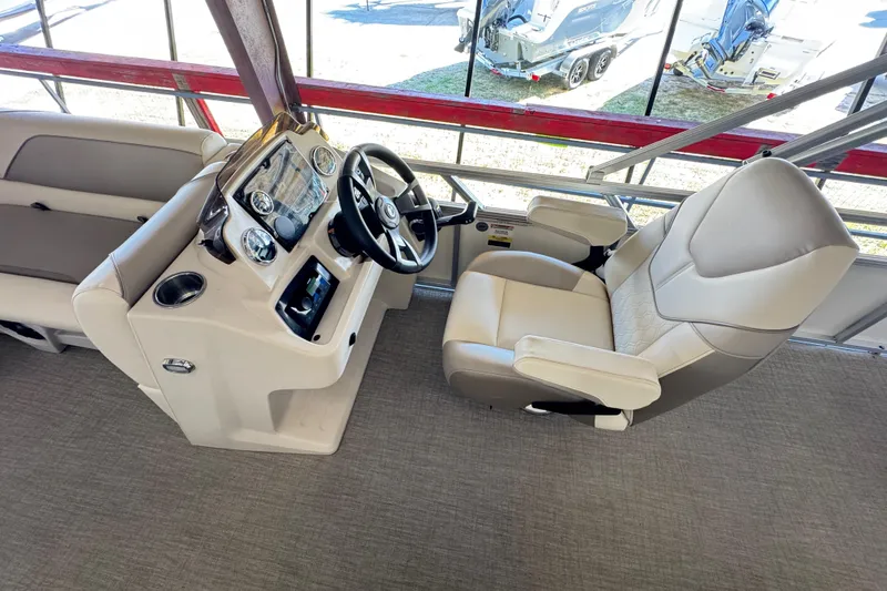 Slide: The Image of Interior of 2025 Avalon 2185 Rear Fish boat with captain's chair and control panel. - 12