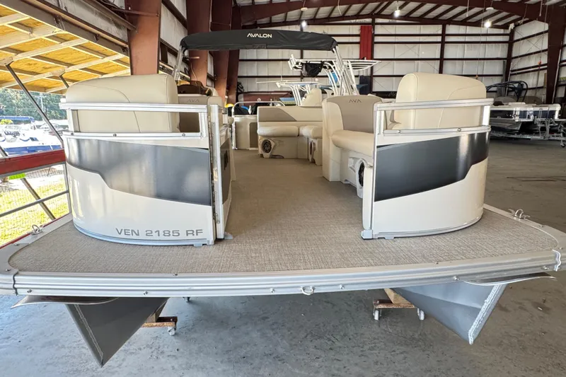 Slide: The Image of 2025 Avalon 2185 Rear Fish pontoon boat in a warehouse setting. - 2