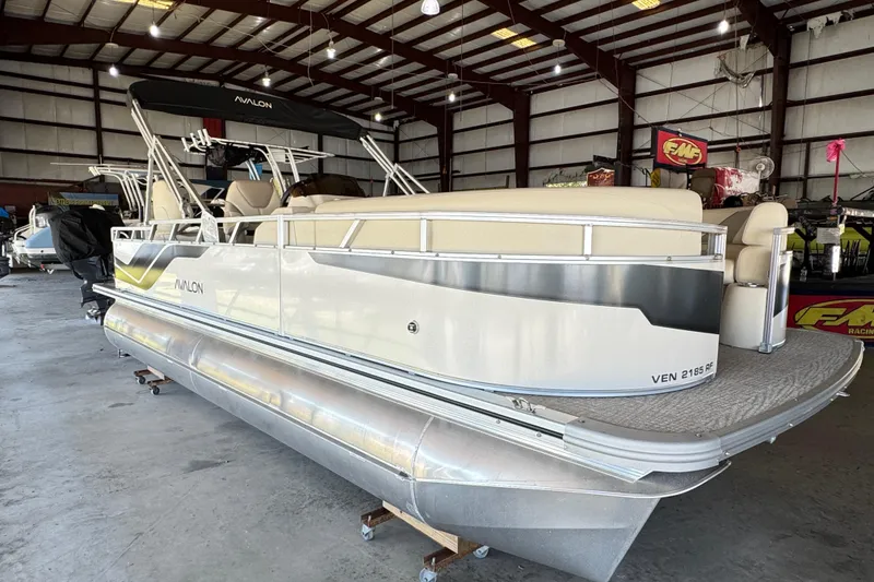 Slide: The Image of 2025 Avalon 2185 Rear Fish pontoon boat in a spacious indoor showroom. - 3