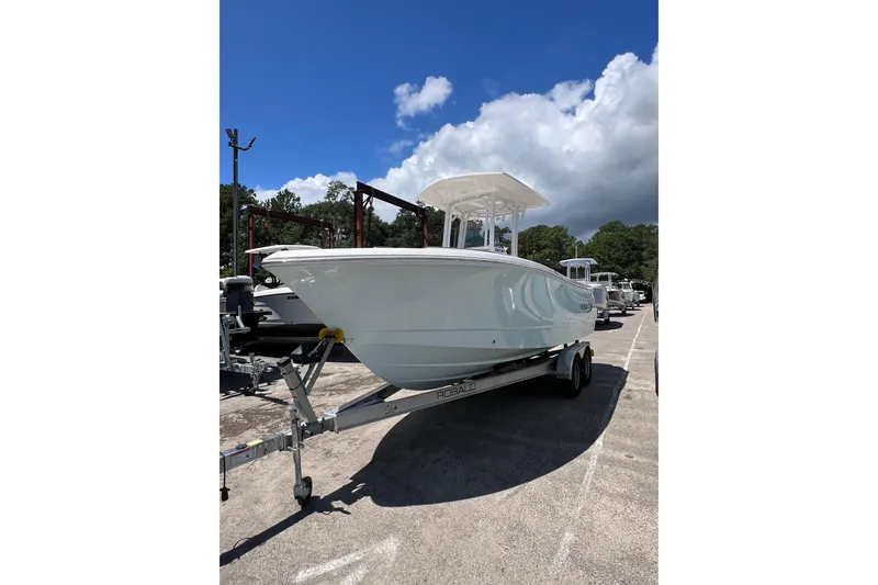 Slide: The Image of 2023 Robalo R230 Center Console boat on trailer under blue sky. - 10