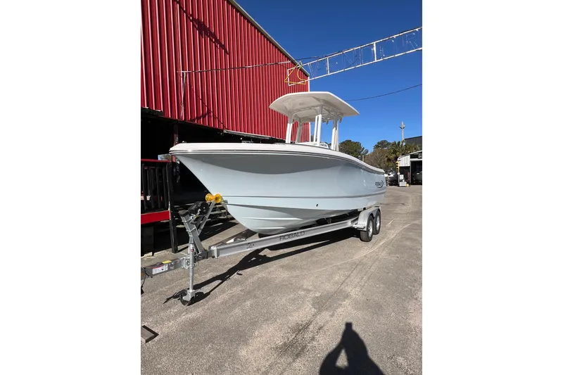Slide: The Image of 2023 Robalo R230 Center Console boat on trailer, parked outdoors. - 3