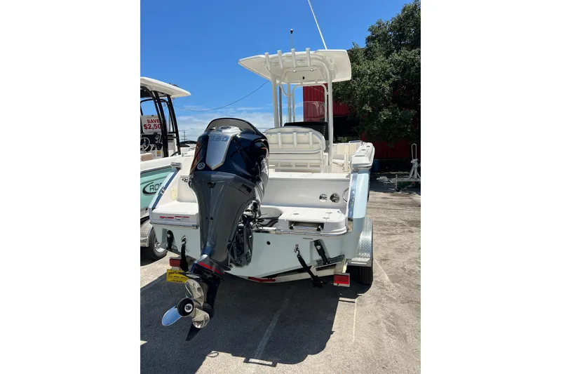 Slide: The Image of 2023 Robalo R230 Center Console boat with powerful outboard motor, parked outdoors. - 7