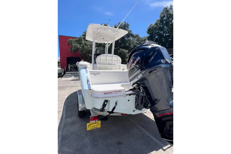 Slide: The Image of 2023 Robalo R230 Center Console boat with Yamaha outboard motor, parked outdoors. - 9