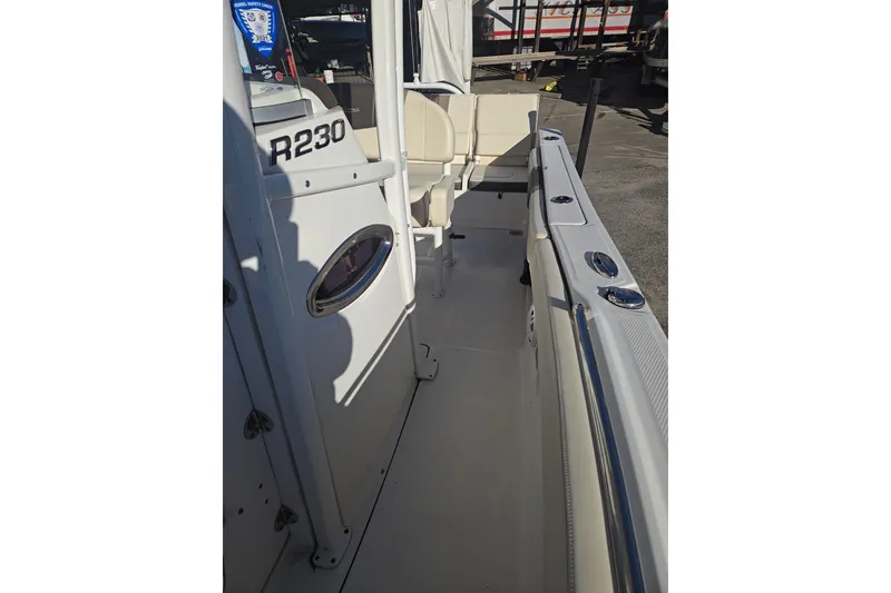 Slide: The Image of 2021 Robalo R230 Center Console boat interior with seating and console details. - 12