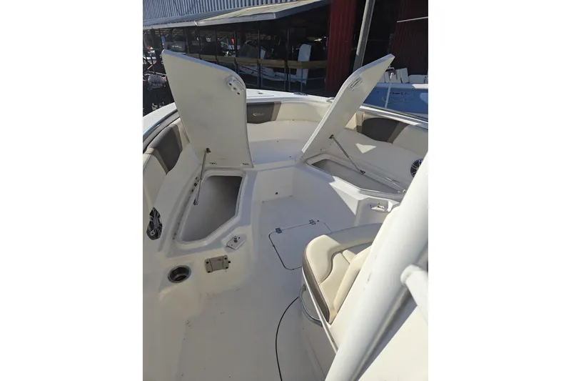 Slide: The Image of 2021 Robalo R230 Center Console boat interior with open storage compartments. - 13