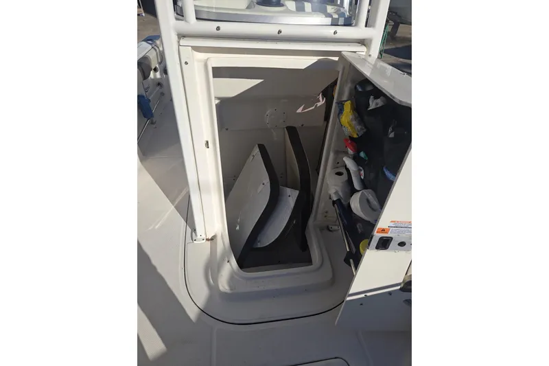 Slide: The Image of 2021 Robalo R230 Center Console storage compartment with organized supplies. - 14