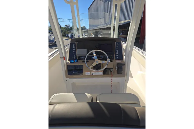 Slide: The Image of 2021 Robalo R230 Center Console boat interior with steering wheel and control panel. - 15