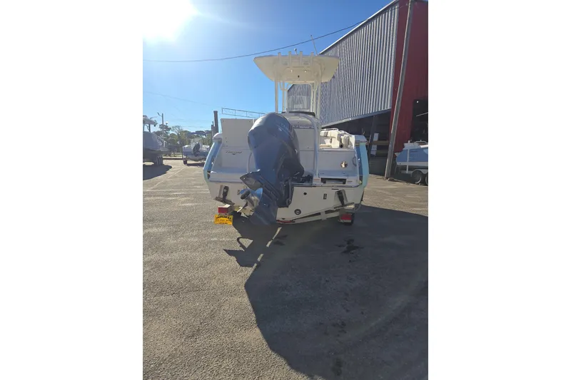 Slide: The Image of 2021 Robalo R230 Center Console boat with outboard motor, parked outdoors. - 6
