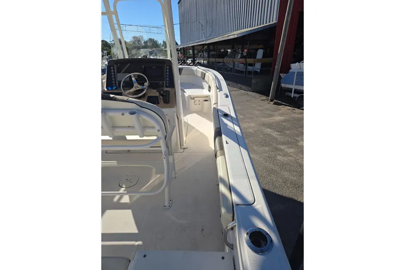 Slide: The Image of 2021 Robalo R230 Center Console boat interior with steering wheel and seating. - 7