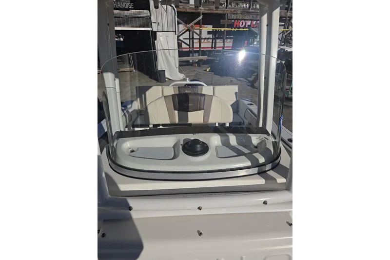 Slide: The Image of 2021 Robalo R230 Center Console boat with windshield and seating, docked outdoors. - 8