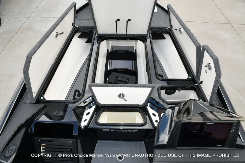 Slide: The Image of 2023 Ranger Z520R boat interior with open storage compartments and navigation equipment. - 12