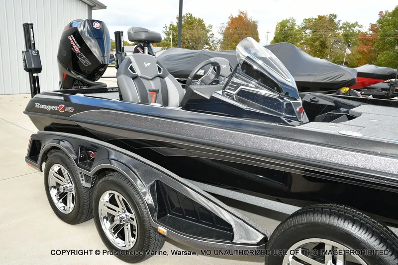 Slide: The Image of 2023 Ranger Z520R bass boat with sleek design and powerful engine, parked outdoors. - 17