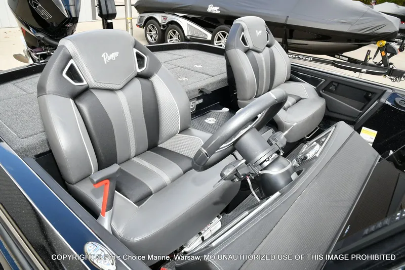 Slide: The Image of 2023 Ranger Z520R boat interior with dual gray seats and steering wheel. - 22