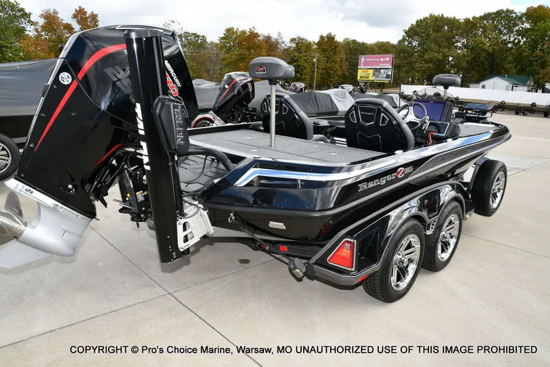 Slide: The Image of 2023 Ranger Z520R boat with Mercury engine, parked on a concrete surface. - 23