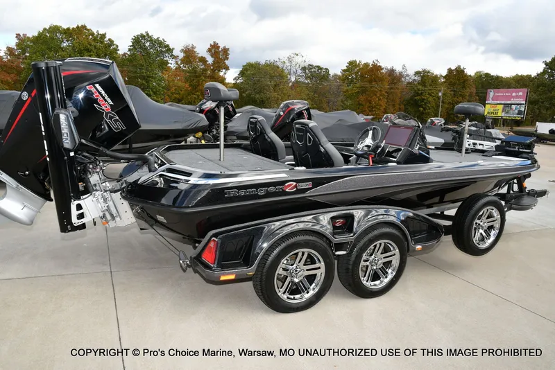Slide: The Image of 2023 Ranger Z520R bass boat with dual engines and sleek design on a trailer. - 24
