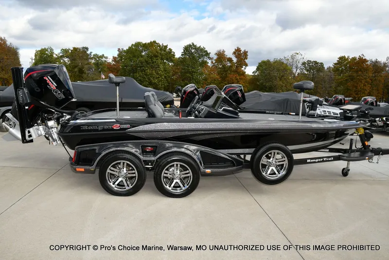 Slide: The Image of 2023 Ranger Z520R boat with dual axles and sleek black design on a trailer. - 25