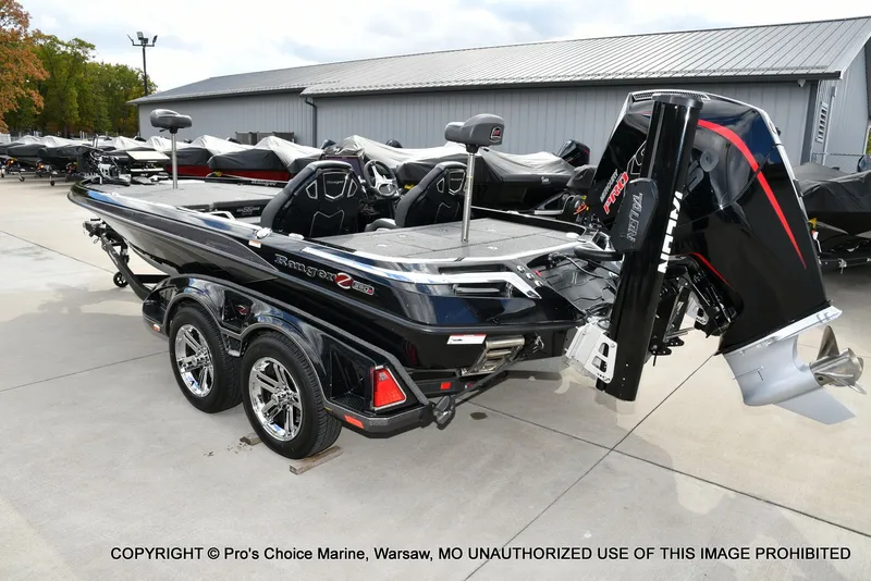 Slide: The Image of 2023 Ranger Z520R boat with dual axle trailer, displayed outdoors. - 29