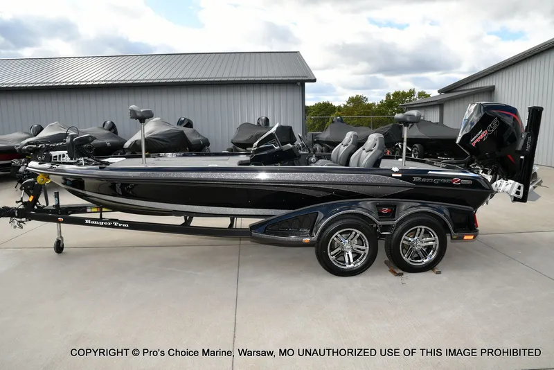 Slide: The Image of 2023 Ranger Z520R bass boat with dual axle trailer, parked outdoors. - 30
