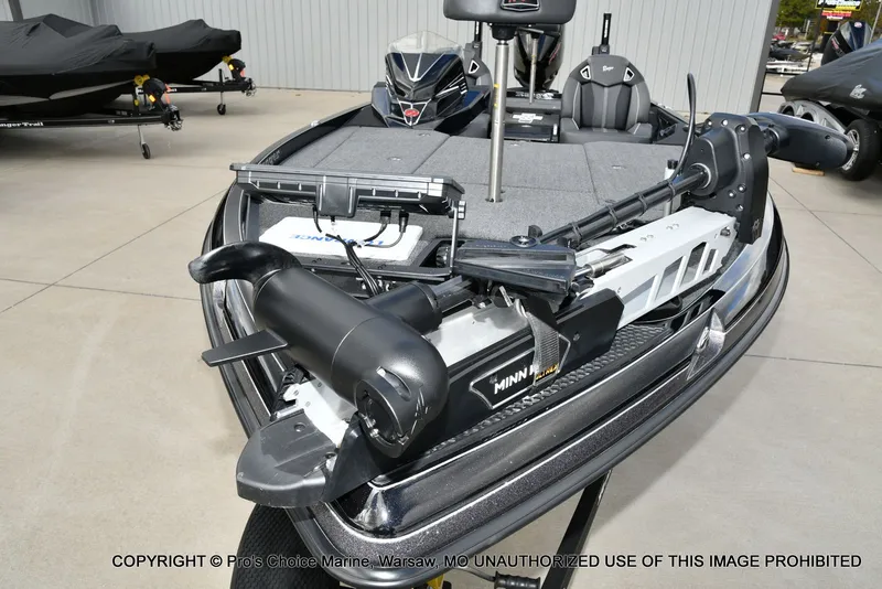 Slide: The Image of 2023 Ranger Z520R boat with Minn Kota trolling motor, displayed outdoors. - 33
